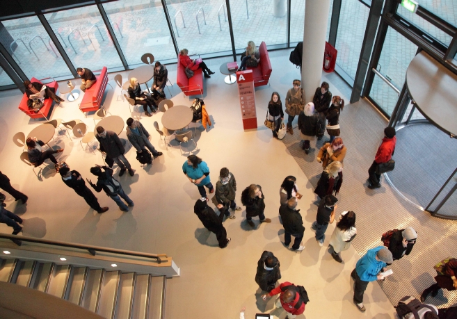 Photographs taken for the opening of the new, City Centre Campus in Newport.  Shows the Student Mentors (in blue) helping students and staff learn the layout of the new campus complex.