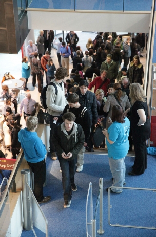 Photographs taken for the opening of the new, City Centre Campus in Newport.  Shows the Student Mentors (in blue) helping students and staff learn the layout of the new campus complex.